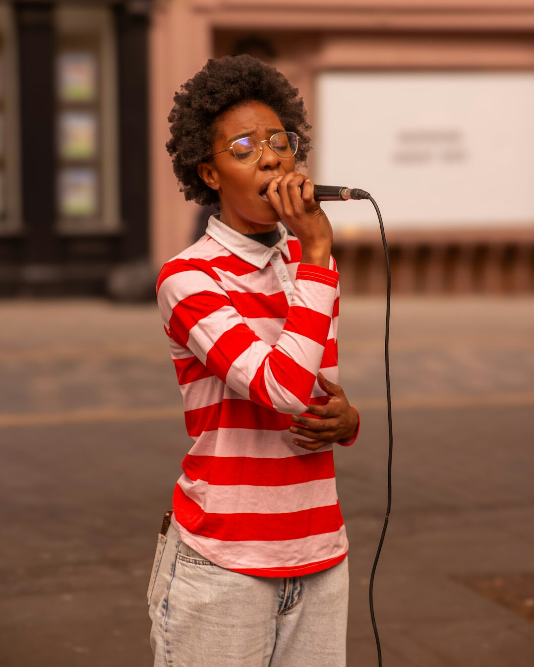 Student practicing voice training with a microphone